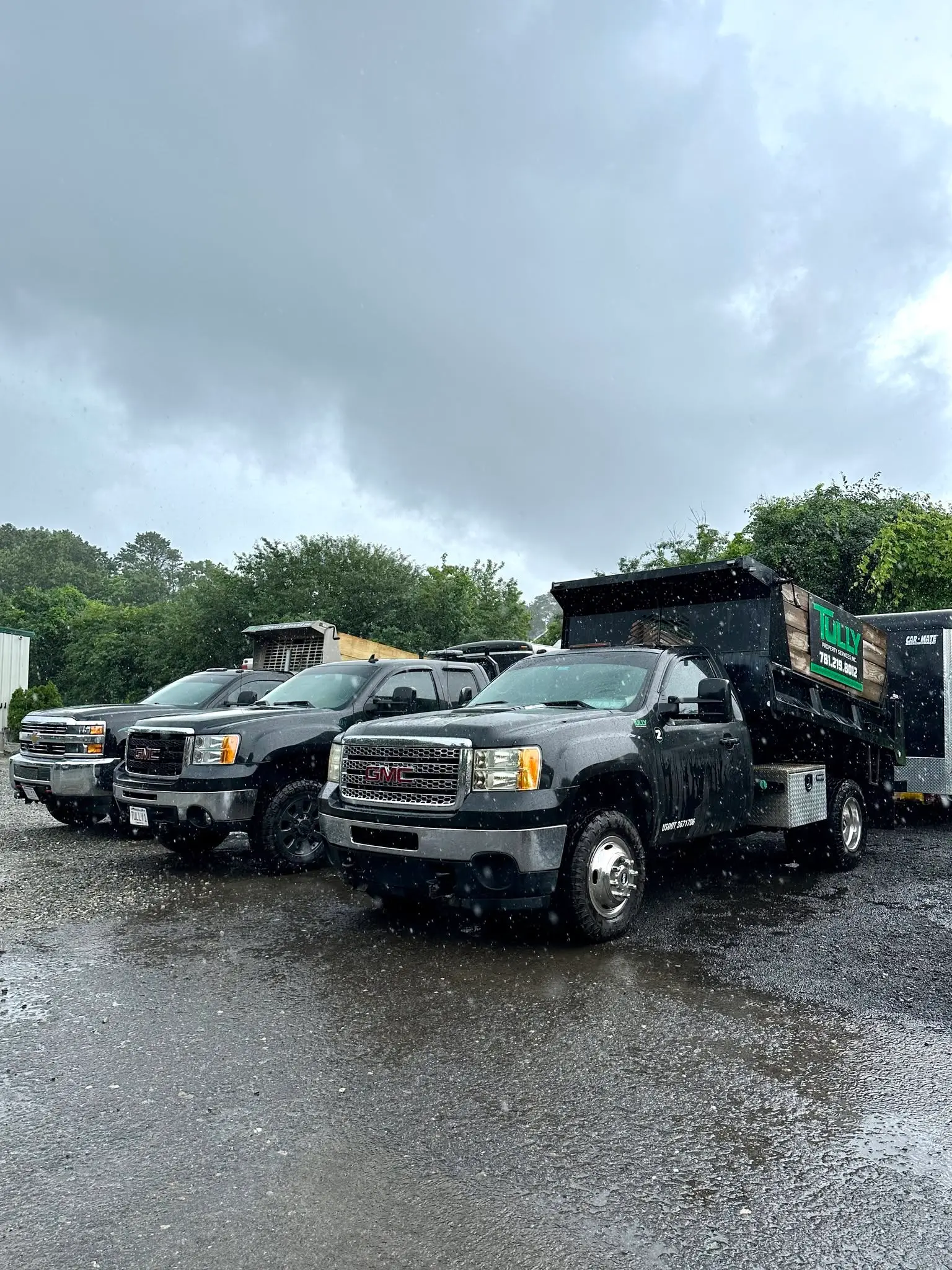 Tully Property Services work trucks with the company’s green signage
